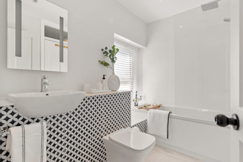 Family bathroom with bath and shower over