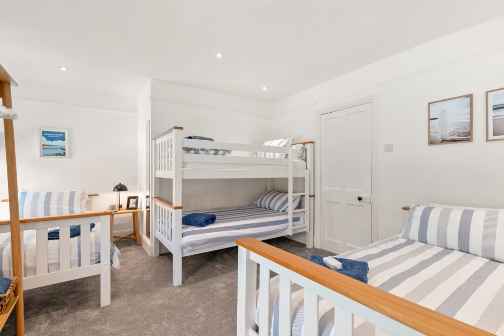 Second bedroom with two single beds and bunk beds
